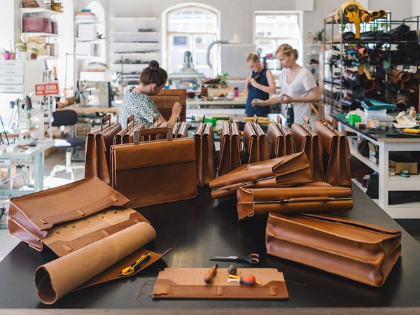brown postal messenger bags in a leather workshop