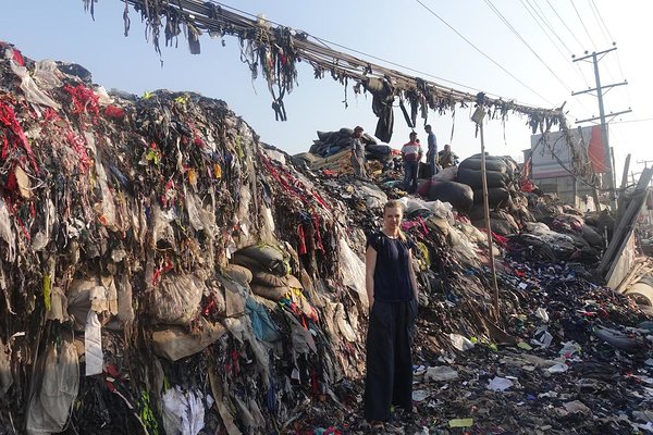 Ann in front of one of the waste dumping sites of an EPZ area in Dhaka