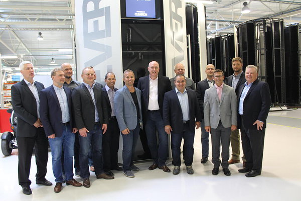 Walmart's delegation posing in front of the Cleveron 401 parcel robot in Cleveron's factory