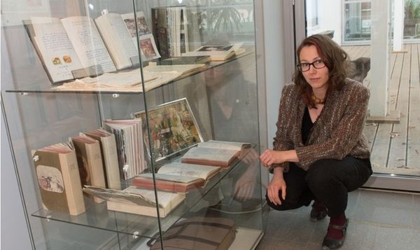 Aija Sakova next to an exhibition of Ivar Ivask&#x27;s archive at Estonian Literary Museum in Tartu (2017).