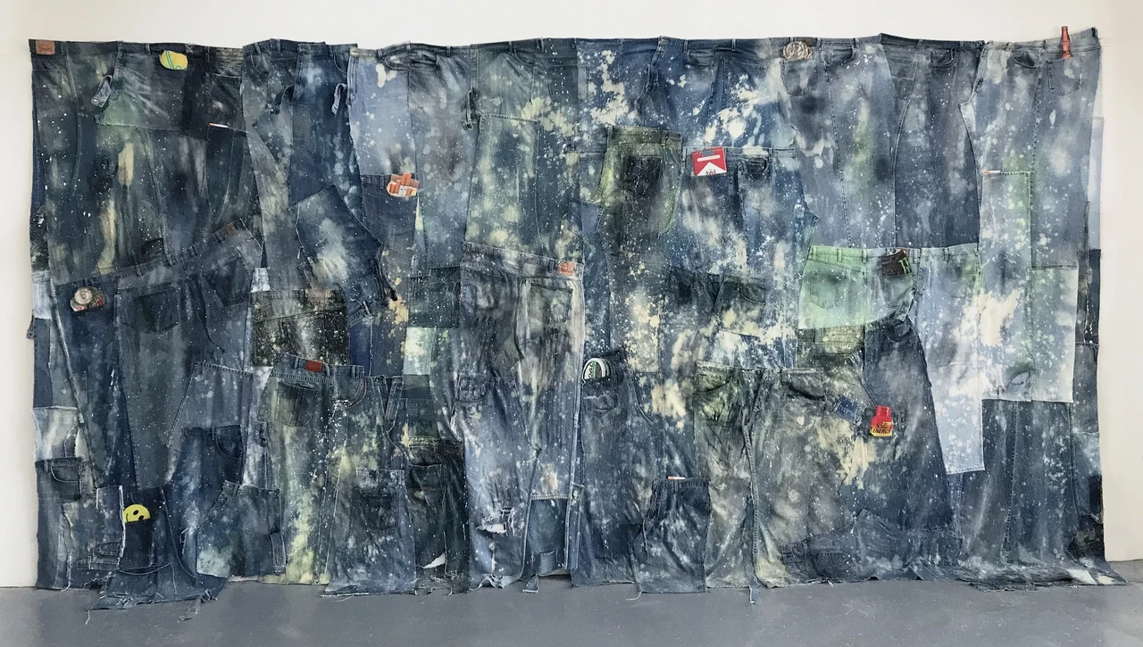 Jeans, 2017-18, upcycled denim, paper cigarettes, inkjet prints on plexiglas, 100 x 196 inches