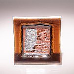 Small fused glass plate, brown with abstract pattern