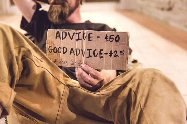 homeless man holding sign that says "advice - 50 cents, good advice 2 dollars"