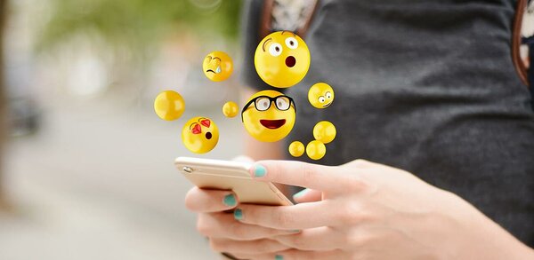 Concept of person texting using emojis