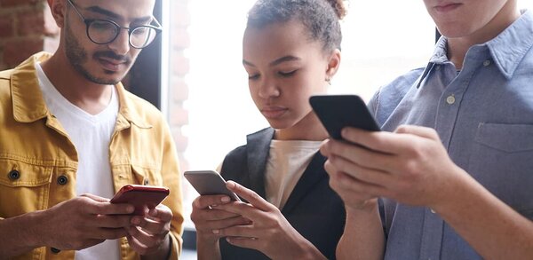 Group of people using mobile phones