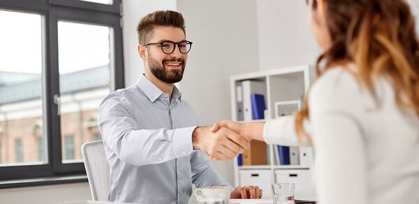 Interview concept - man and woman shaking hands