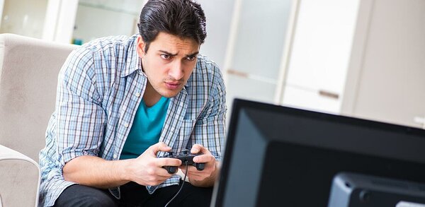Person gaming and looking at monitor