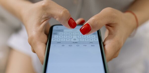 Person typing a text message on mobile phone