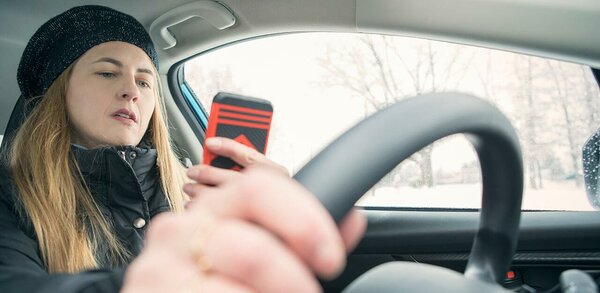 Woman using a phone while driving