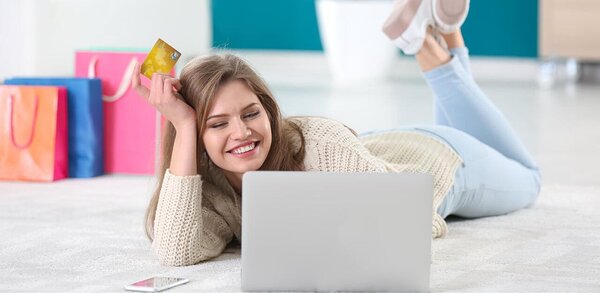 Happy person shopping on laptop with credit card