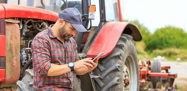 Farmer using a smartphone on a field