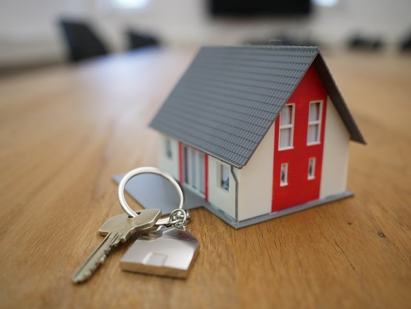 Tiny model house with keys on a table