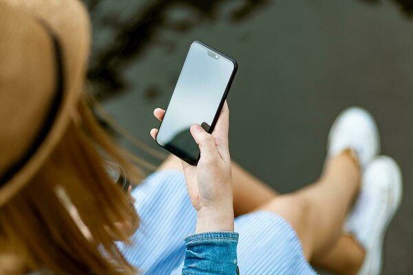 Young woman checking her smartphone for SMS messages