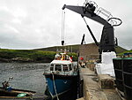 Foula pier, luggage is lifted on shore