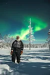Northern lights hunting in a snow covered forest