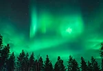 Northern Lights in a cloudy sky in Rovaniemi Lapland Finland