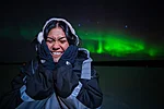 Excited customer in a northern lights portrait