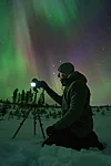 One of Beyond Arctic&#x27;s photographers taking pictures of the auroras in Rovaniemi Finland