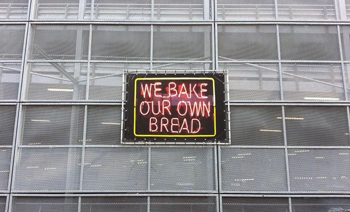 &quot;We Bake Our Own Bread,&quot; UV print on vinyl, steel frame