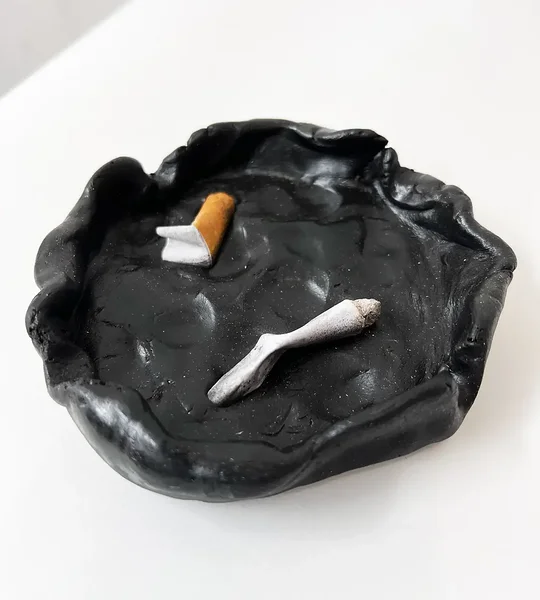 Long Day, 2023, epoxy resin, paper cigarettes, 1 x 4 x 4 inches