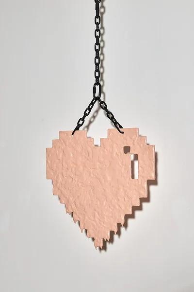 Pixel Heart (melting salmon), 2026, dibond, epoxy, alkyd, powder coated steel chain, hardware, 23 1/2 x 24 x 3/4 inches 