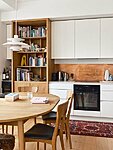 white bespoke kitchen with a ceramic worktop, veneer bookshelf and a minibar