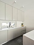 light grey bespoke kitchen with veneer cupboard