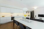 white bespoke kitchen, shelves, wardrobe and dining table