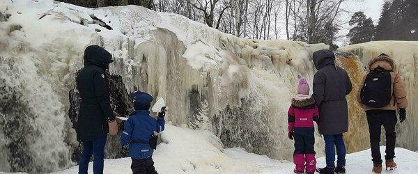 Admiring the ice curtains on Keila-Joa waterfall. C.Kressa