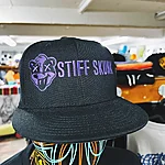 Stiffskunk black cap purple logo 3