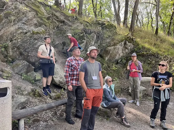 Enjoing the Kärdla impact site with heavily deformed basement rocks on the background. Photo: Triinu Jairus