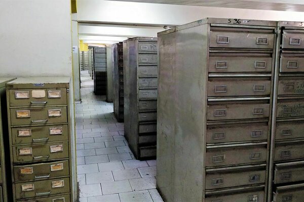 Extensive filing cabinet archives at Dominican government office containing thousands of birth and civil registry records