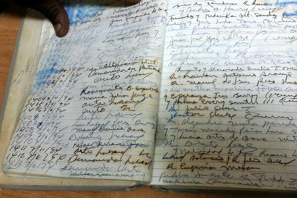 searching through the book of land titles from San Cristobal