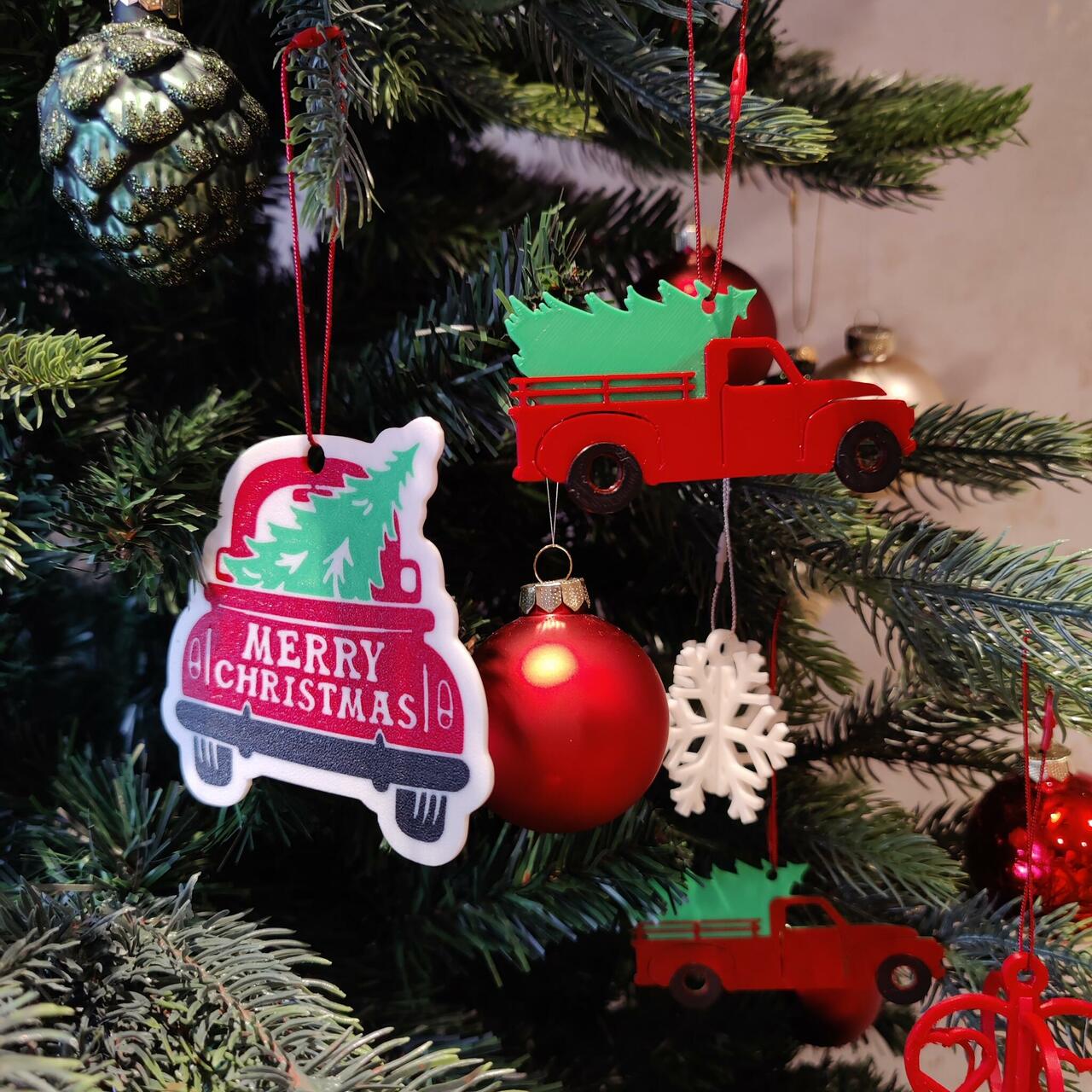 red truck carrying christmas tree