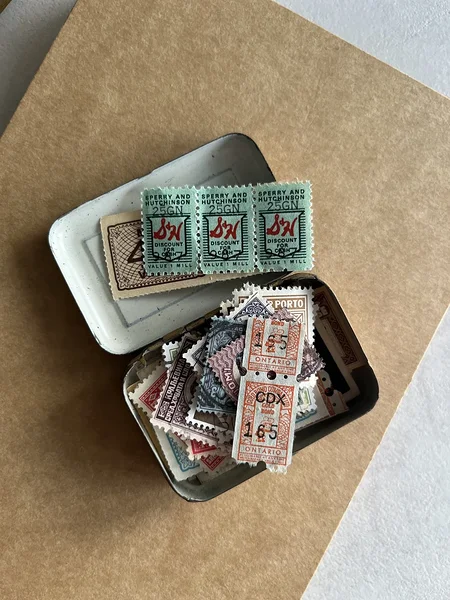 [vintage] medicine tin filled with stamps