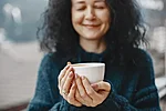 Winter vacation mountains curly hair women white cup with coffee