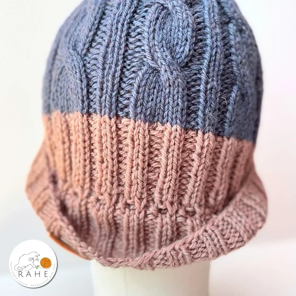 Close-up of hand-knitted cable pattern in blue and beige repurposed wool – winter hat for women and men by RAHEcraft.
