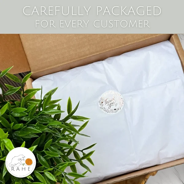 RAHEcraft handmade knitwear packaging in eco friendly box, carefully wrapped leg warmers in tissue paper with thank you sticker, small business packaging aesthetic, gift ready handmade wool accessories