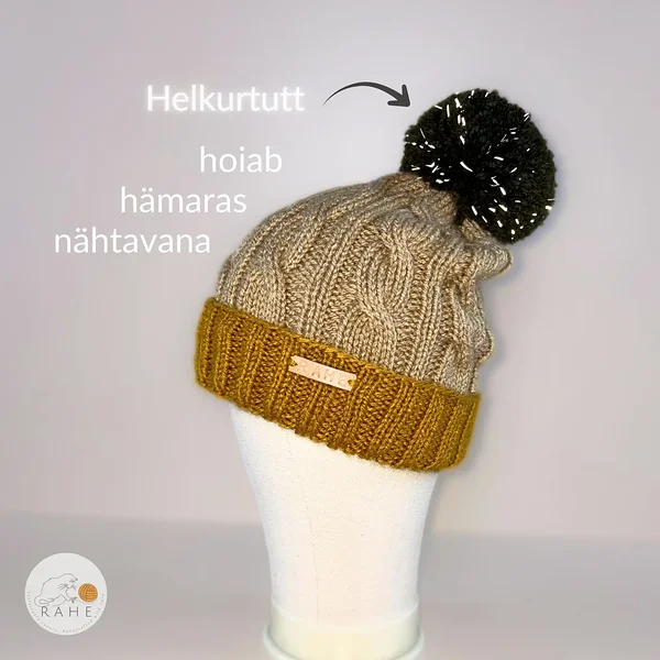 Beež kootud talvemüts sinepikollase topeltsooniku ja tumerohelise helkurtituga.  Käsitsi kootud Eestis.