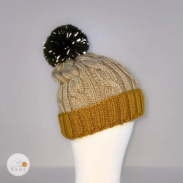 Kids knitted winter beanie with a large reflective pom pom. 