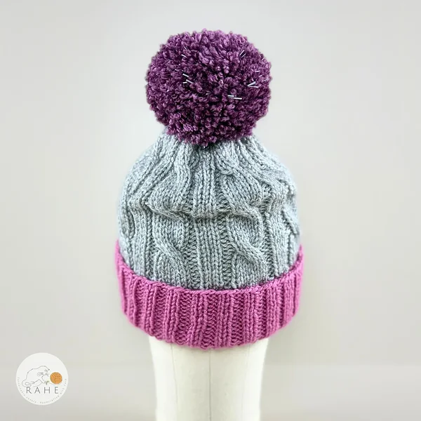 Hand knit hats. Reflective knitted winter hats with reflective poms. Multi coloured cable knit beanie in pink, grey, and lilac. Handmade in Estonia.