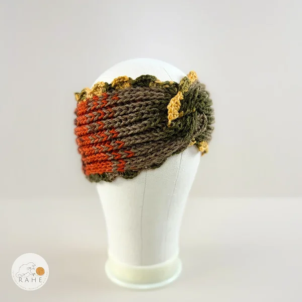 Hand-knitted wide acrylic headband on mannequin head, moss green, orange, beige, and mustard yellow gradient headband with twisted detail, fisherman's rib knit texture, crocheted scalloped edge, RAHEcraft