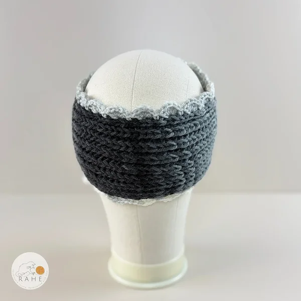 Back view of hand-knitted wide acrylic headband in grey tones on mannequin, dense textured knit with crocheted scalloped lace edge, seamless finish, RAHEcraft