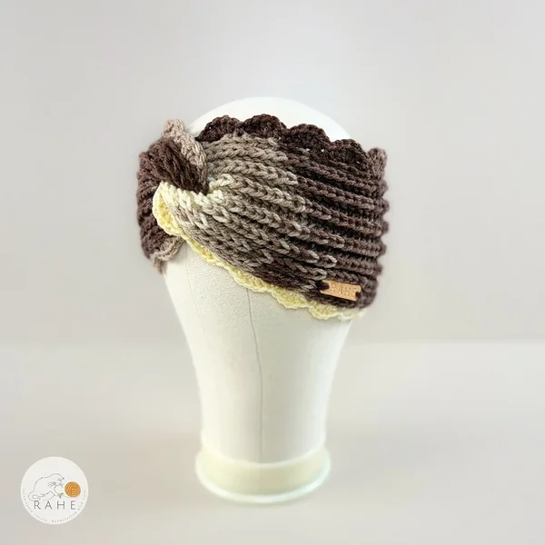 Angled back view of a hand-knitted wide acrylic headband, brown and beige color blend, crocheted scalloped lace edge, mannequin head, RAHEcraft
