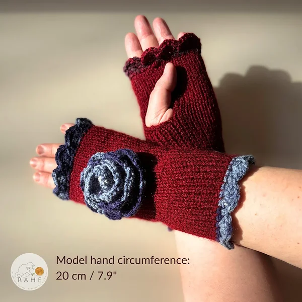 Hand-knitted dark red fingerless gloves with thumb opening and lace edging, worn on a model – hand circumference 20 cm (7.9").