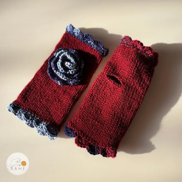 Hand-knitted dark red fingerless gloves with lace edging and a crocheted flower – warm handmade gloves perfect for autumn and winter.