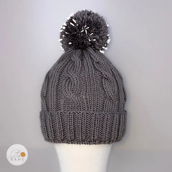 Hand-knitted merino wool grey cable knit winter hat with a reflective bobble. Unisex winter hat. Estonian handmade gifts.