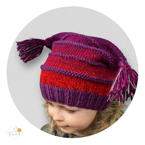Child wearing a RAHEcraft hand-knitted reflective winter hat with striped knit pattern and reflective tassels, suitable for kids and adults. Handmade in Estonia, in Europe.