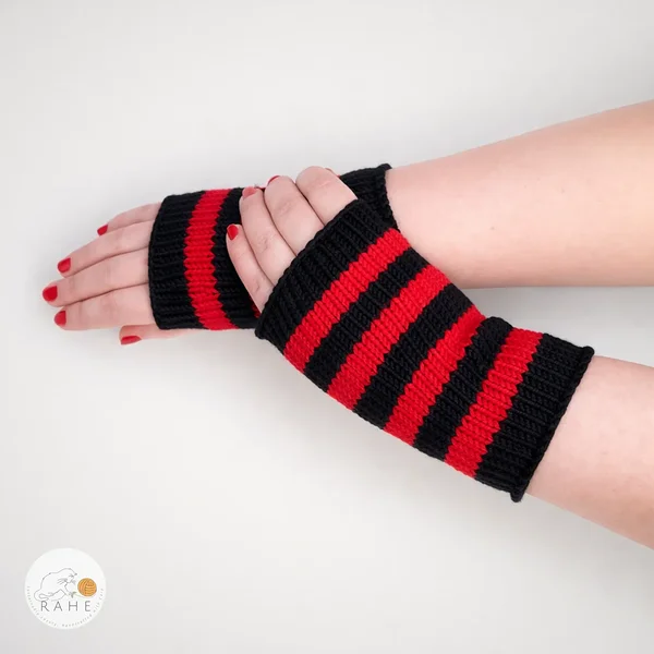 Hand-knitted merino wool arm warmers with black and red stripes, worn on crossed hands. RAHEcraft.