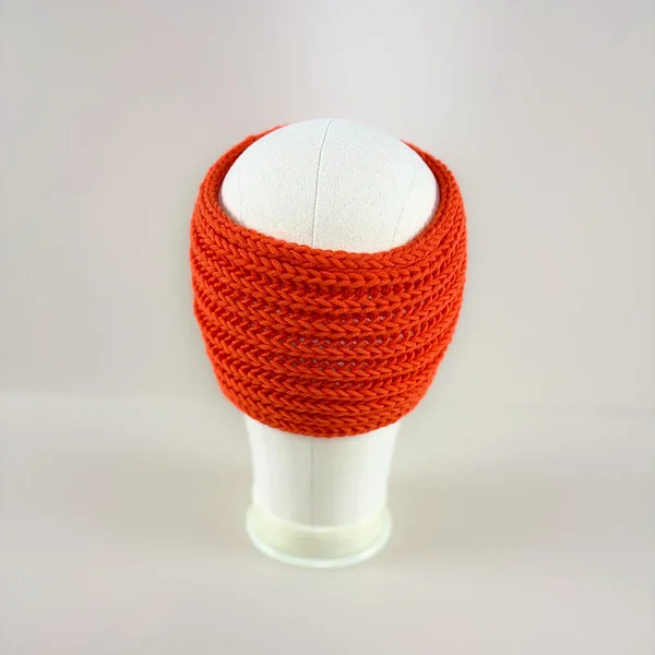Back view of a hand-knitted bright orange merino wool ear warmers for girls and women.